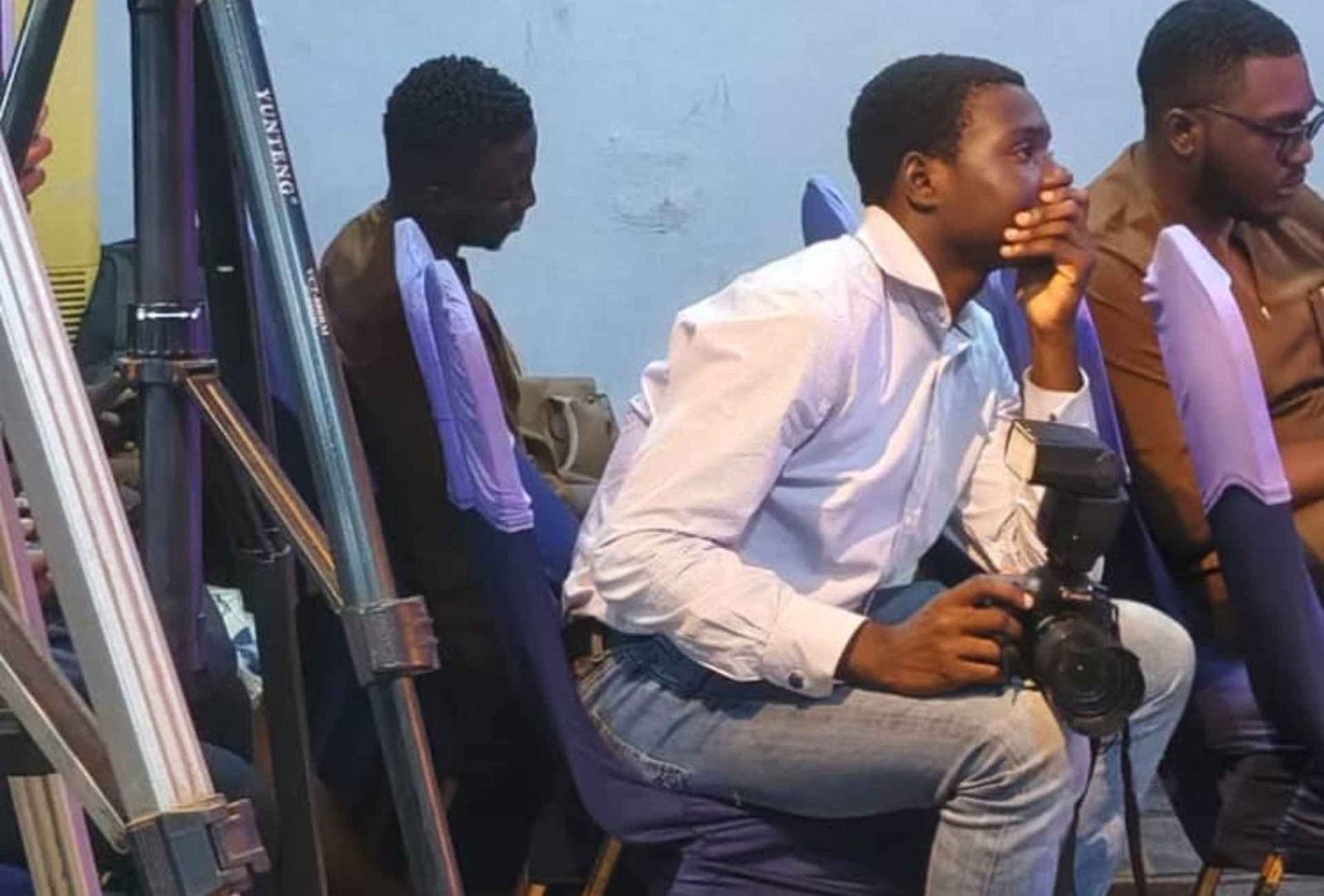 Anzolo at friends connect leading the africa awakening seated congrigation with camera man